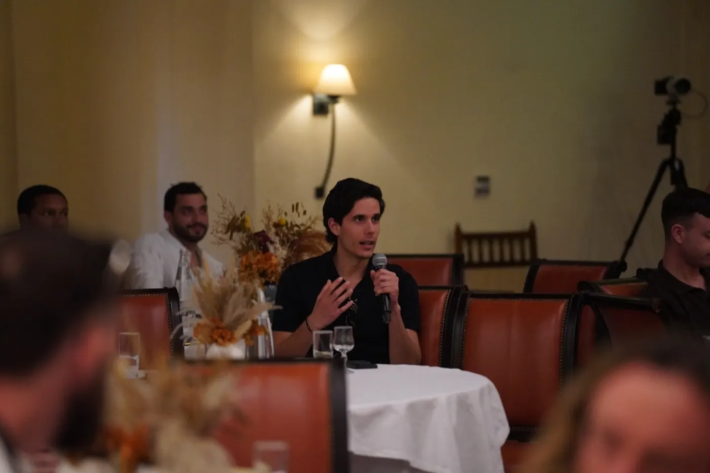 Alex Klaric speaking on stage at the Consulting.com mastermind dinner in Dubai