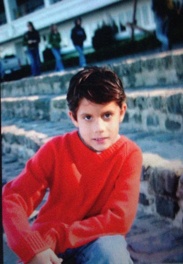 Alex Klaric as a boy in a red sweater, after his family moved from Guadalajara to San Diego